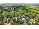 Scenic aerial view of a home in a verdant neighborhood, complemented by nearby lakes and green spaces at 1018 E Highland Dr, Lakeland, FL 33813