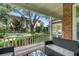 Enjoy outdoor living on this covered porch with comfortable seating and a serene view of the landscaped yard at 1018 E Highland Dr, Lakeland, FL 33813