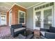 Covered porch offers comfortable seating and stylish brick flooring, an ideal spot for outdoor relaxation at 1018 E Highland Dr, Lakeland, FL 33813