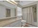 Clean bathroom with granite countertops, vanity sink, tile floors, and a tub and shower combo at 1018 E Highland Dr, Lakeland, FL 33813