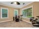 Cozy bedroom with a ceiling fan, carpet, and large windows overlooking the backyard at 1018 E Highland Dr, Lakeland, FL 33813
