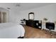 This bedroom has warm-toned laminate flooring, white walls and trim, a desk, and a keyboard stand at 1018 E Highland Dr, Lakeland, FL 33813