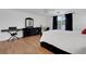 Bedroom with laminate flooring, white walls, white trim, dark furniture, and nice natural lighting at 1018 E Highland Dr, Lakeland, FL 33813
