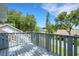 Painted outdoor deck features a beautiful view to neighboring houses and large green trees and foliage at 1018 E Highland Dr, Lakeland, FL 33813