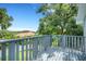 Outdoor deck has a painted gray wood floor and railings with a view of neighboring homes and mature trees at 1018 E Highland Dr, Lakeland, FL 33813