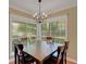 Charming dining room with a modern chandelier and window view of the outdoors at 1018 E Highland Dr, Lakeland, FL 33813