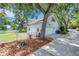 A well-maintained exterior with a gray two-story home, driveway, and tree-lined property at 1018 E Highland Dr, Lakeland, FL 33813