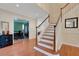 Spacious foyer with hardwood floors, staircase, and views into the dining room at 1018 E Highland Dr, Lakeland, FL 33813