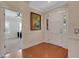 Welcoming foyer with a white front door, hardwood floors, and decorative wall art at 1018 E Highland Dr, Lakeland, FL 33813