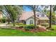 Charming two-story home with mature trees, lush landscaping, and inviting front porch at 1018 E Highland Dr, Lakeland, FL 33813
