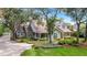 Charming two-story home featuring mature trees, a landscaped yard, and a welcoming front porch at 1018 E Highland Dr, Lakeland, FL 33813