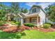 Inviting home featuring a brick-accented porch, manicured lawn, and charming curb appeal at 1018 E Highland Dr, Lakeland, FL 33813