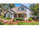 Beautiful two-story home showcasing a blend of siding and brick, enhanced by a manicured front yard at 1018 E Highland Dr, Lakeland, FL 33813