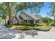 Beautiful home featuring mature trees, lush landscaping, and a welcoming entrance for a grand first impression at 1018 E Highland Dr, Lakeland, FL 33813