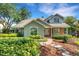 Charming home with brick accents, a well-manicured lawn, and lush landscaping for added curb appeal at 1018 E Highland Dr, Lakeland, FL 33813