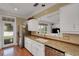 Bright kitchen features stainless steel appliances, granite countertops, and white cabinetry at 1018 E Highland Dr, Lakeland, FL 33813