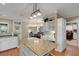 Beautiful kitchen with white cabinets, granite countertops, a light fixture, and a view to the breakfast nook at 1018 E Highland Dr, Lakeland, FL 33813