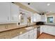 Kitchen has stainless steel appliances, granite countertops, and white cabinets at 1018 E Highland Dr, Lakeland, FL 33813