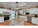 Bright kitchen featuring a center island, modern appliances, and white cabinetry at 1018 E Highland Dr, Lakeland, FL 33813