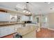 Open kitchen with granite countertops, white cabinets, island, and stainless appliances at 1018 E Highland Dr, Lakeland, FL 33813