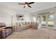 Cozy living room with a view of the kitchen and access to the backyard at 1018 E Highland Dr, Lakeland, FL 33813