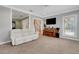 Inviting living room featuring a comfortable white sofa, piano, and staircase access at 1018 E Highland Dr, Lakeland, FL 33813