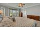 Comfortable main bedroom with a ceiling fan and french doors to a patio at 1018 E Highland Dr, Lakeland, FL 33813