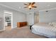 Spacious main bedroom with plush carpet, a ceiling fan, and ensuite bathroom at 1018 E Highland Dr, Lakeland, FL 33813