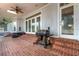 Covered patio with brick flooring, a grill, and a ceiling fan for outdoor entertaining at 1018 E Highland Dr, Lakeland, FL 33813