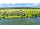 Aerial view showcasing vast homesites near a serene lake and lush green landscape at 1044 Timbers Dr, Fort Meade, FL 33841