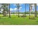 Picturesque backyard with a swing set, picnic table, and beautiful lake views at 1044 Timbers Dr, Fort Meade, FL 33841