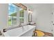 Serene bathroom with a soaking tub overlooking a picturesque outdoor view at 1044 Timbers Dr, Fort Meade, FL 33841