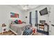 Bedroom with patriotic decor, desk and chair, and wood flooring at 1044 Timbers Dr, Fort Meade, FL 33841