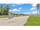 Gated entrance to the property with a white fence and brick pillars, providing security and curb appeal at 1044 Timbers Dr, Fort Meade, FL 33841