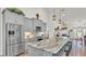 Bright and open kitchen with a large island, stainless steel appliances, and stylish pendant lighting at 1044 Timbers Dr, Fort Meade, FL 33841