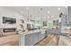 Open concept kitchen with a large island, stainless steel appliances, and seamless flow into the living area with fireplace at 1044 Timbers Dr, Fort Meade, FL 33841