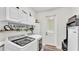 Bright laundry room with modern washer and dryer, ample storage cabinets, and an exterior door at 1044 Timbers Dr, Fort Meade, FL 33841