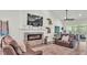 Bright living room with a stone fireplace, large TV, and comfortable seating at 1044 Timbers Dr, Fort Meade, FL 33841