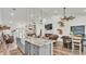 Open concept living space featuring a large kitchen island, fireplace, and dining area at 1044 Timbers Dr, Fort Meade, FL 33841