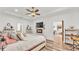 Stylish main bedroom with a tray ceiling, fireplace, and wood-look flooring at 1044 Timbers Dr, Fort Meade, FL 33841