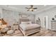 Inviting main bedroom showcasing a decorative brick wall, tray ceiling, and neutral décor at 1044 Timbers Dr, Fort Meade, FL 33841