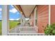 Inviting front porch with swing, ideal for relaxing and enjoying views of the surrounding landscape at 1044 Timbers Dr, Fort Meade, FL 33841