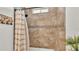 Shower-tub combo featuring decorative tile surround with shower curtain and window above at 1044 Timbers Dr, Fort Meade, FL 33841