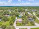 An aerial shot displays a well-established neighborhood surrounded by mature trees and lush greenery at 1102 Berkley Ln, Winter Haven, FL 33880