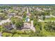 Aerial view showcasing a residential neighborhood, surrounded by lush, mature trees at 1102 Berkley Ln, Winter Haven, FL 33880