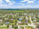 An aerial view of a neighborhood with tree-lined streets and well-maintained homes at 1102 Berkley Ln, Winter Haven, FL 33880