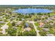 An aerial view of a lakeside neighborhood featuring beautiful homes with mature trees at 1102 Berkley Ln, Winter Haven, FL 33880