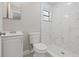 Renovated bathroom featuring a tiled walk-in shower, modern vanity, and neutral color scheme at 1102 Berkley Ln, Winter Haven, FL 33880