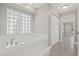 Inviting bathroom with large soaking tub and bright lighting at 1102 Berkley Ln, Winter Haven, FL 33880