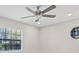 Bright bedroom with modern ceiling fan, and a round window providing natural light and style at 1102 Berkley Ln, Winter Haven, FL 33880